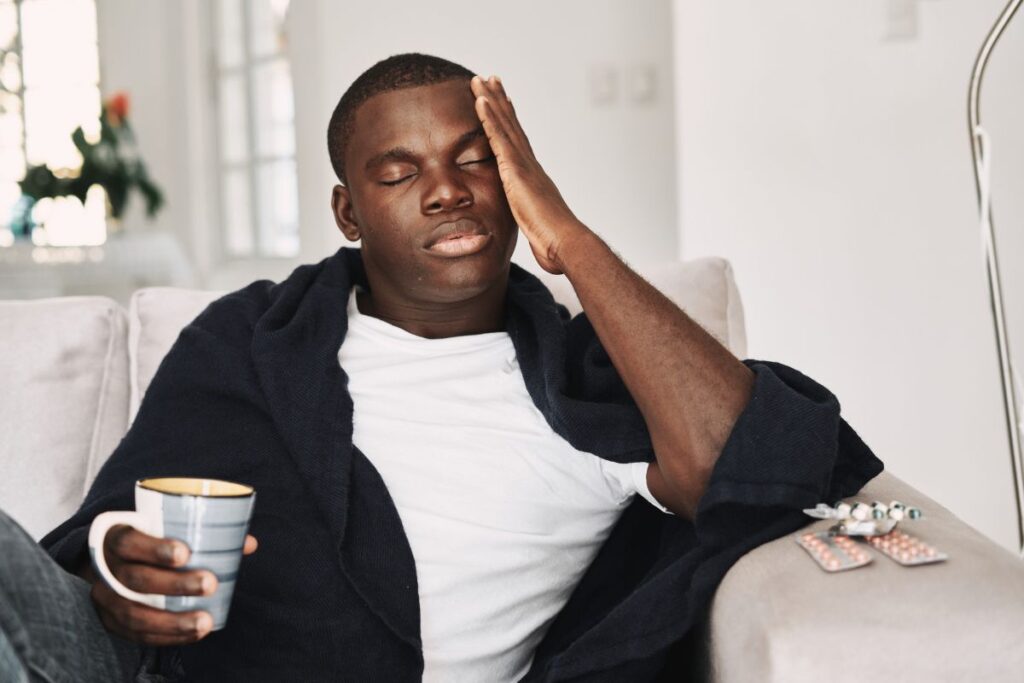 man clutching head in the morning