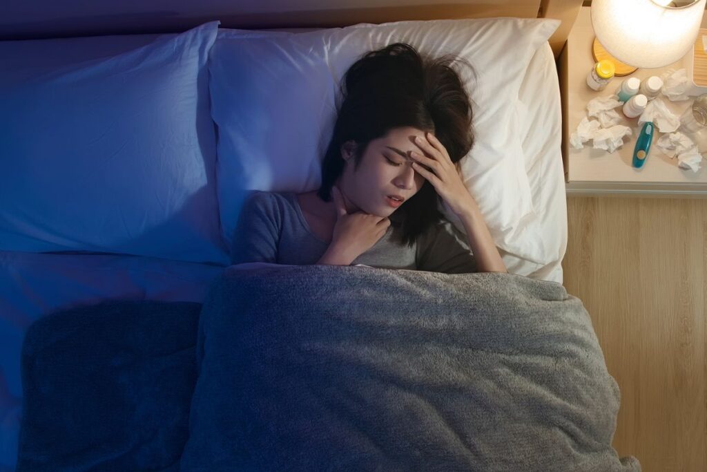 woman suffering from acid reflux in bed